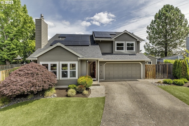 16541 NW Meadow Grass Ct, Beaverton, OR 97006 - traditional-style house featuring roof with shingles, driveway, an attached garage, a chimney, and roof mounted solar panels