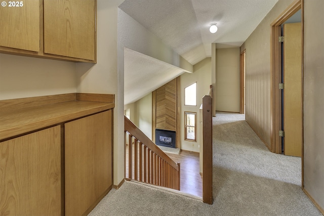 16541 NW Meadow Grass Ct, Beaverton, OR 97006 - corridor featuring light carpet, vaulted ceiling, and a textured ceiling