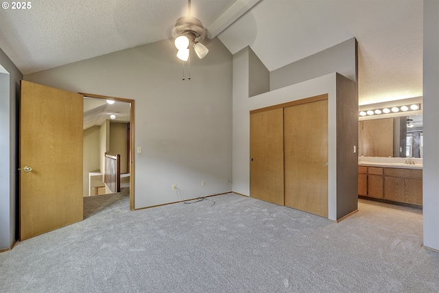 16541 NW Meadow Grass Ct, Beaverton, OR 97006 - unfurnished bedroom featuring light carpet, a closet, high vaulted ceiling, ensuite bathroom, and a textured ceiling
