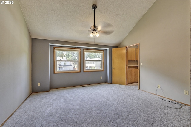 16541 NW Meadow Grass Ct, Beaverton, OR 97006 - unfurnished bedroom with light carpet, a textured ceiling, vaulted ceiling, and a ceiling fan