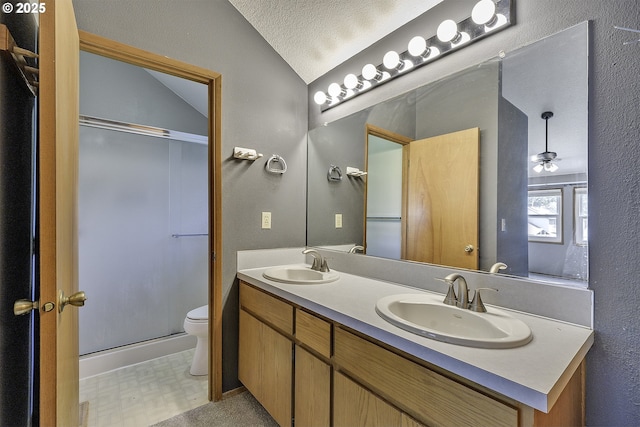 16541 NW Meadow Grass Ct, Beaverton, OR 97006 - bathroom with vaulted ceiling, double vanity, a textured ceiling, and a shower with shower door