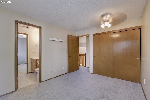 16541 NW Meadow Grass Ct, Beaverton, OR 97006 - unfurnished bedroom featuring light colored carpet, connected bathroom, a textured ceiling, and a closet