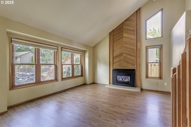 16541 NW Meadow Grass Ct, Beaverton, OR 97006 - unfurnished living room with high vaulted ceiling, healthy amount of natural light, a large fireplace, and wood finished floors