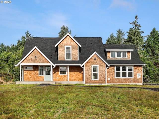 90190 Hobie Rd, Warrenton, OR 97146 - shingle-style home with a front yard and a shingled roof