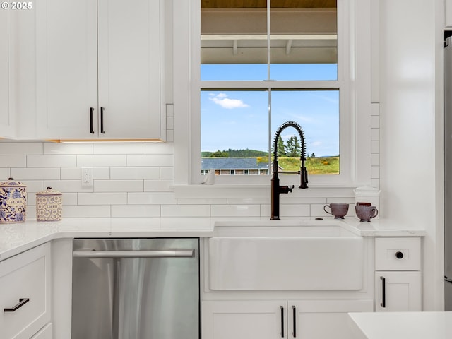 90190 Hobie Rd, Warrenton, OR 97146 - kitchen featuring dishwasher, decorative backsplash, white cabinets, and light countertops