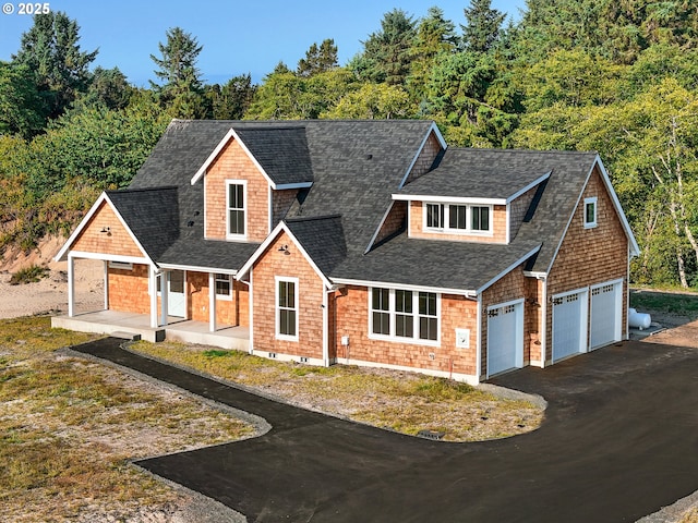 90190 Hobie Rd, Warrenton, OR 97146 - shingle-style home with a shingled roof, asphalt driveway, and covered porch