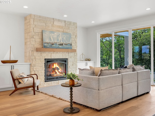 90190 Hobie Rd, Warrenton, OR 97146 - living area featuring wood finished floors, a stone fireplace, and recessed lighting