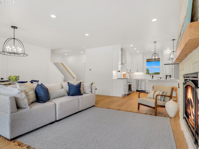 90190 Hobie Rd, Warrenton, OR 97146 - living room with a chandelier, light wood-type flooring, stairs, and recessed lighting