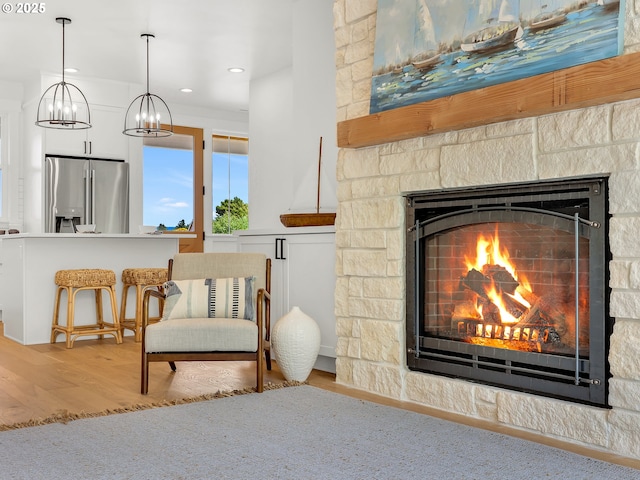 90190 Hobie Rd, Warrenton, OR 97146 - living area featuring a fireplace, wood finished floors, a chandelier, and recessed lighting