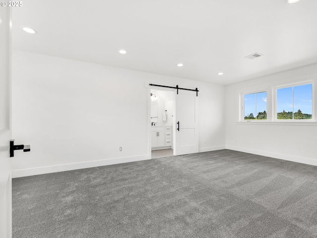 90190 Hobie Rd, Warrenton, OR 97146 - carpeted empty room with a barn door and recessed lighting