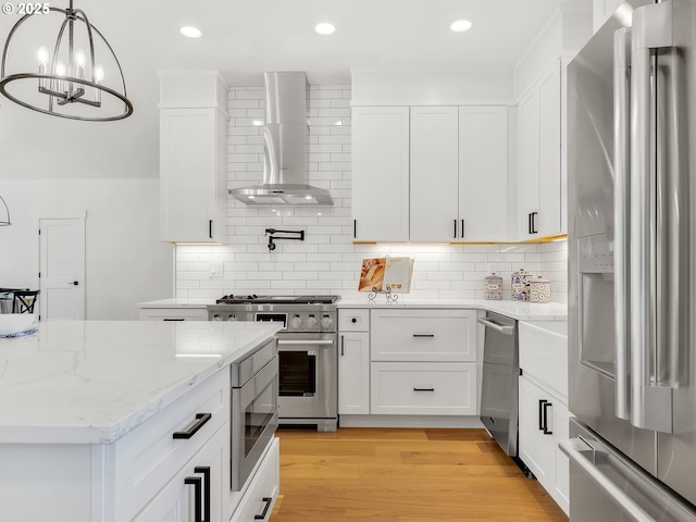 90190 Hobie Rd, Warrenton, OR 97146 - kitchen with stainless steel appliances, wall chimney range hood, white cabinetry, backsplash, and recessed lighting