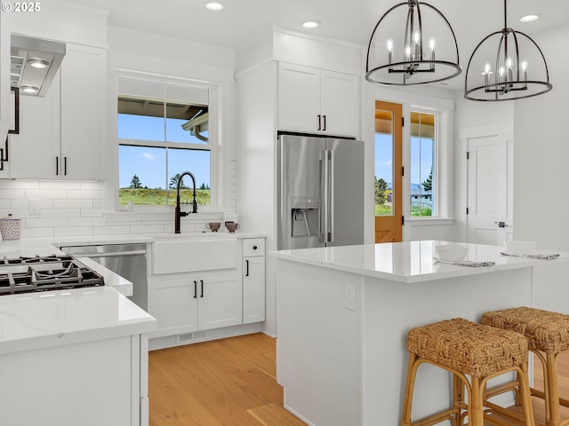 90190 Hobie Rd, Warrenton, OR 97146 - kitchen featuring stainless steel refrigerator with ice dispenser, a chandelier, white cabinets, and recessed lighting
