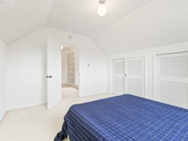 767 NE 152nd Ave, Portland, OR 97230 - carpeted bedroom with vaulted ceiling, a textured ceiling, and multiple closets