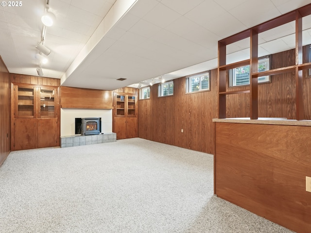 767 NE 152nd Ave, Portland, OR 97230 - unfurnished living room featuring track lighting, wood walls, and carpet flooring
