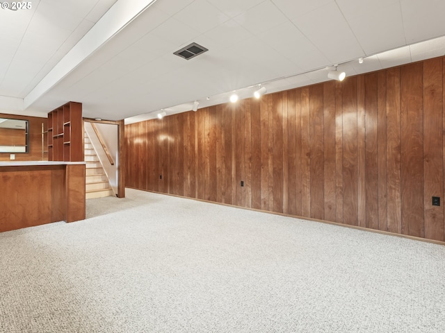 767 NE 152nd Ave, Portland, OR 97230 - finished basement with rail lighting, wooden walls, stairway, and light carpet
