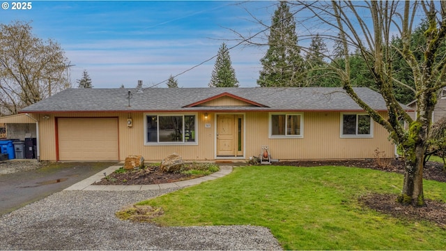 ranch-style home featuring a garage, aphalt driveway, and a front yard