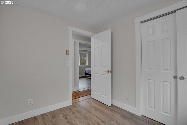 unfurnished bedroom featuring baseboards and light wood-style floors