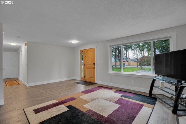 interior space featuring baseboards and wood finished floors