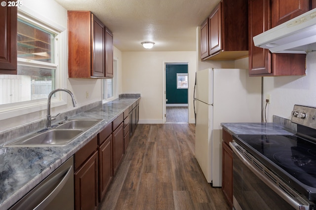 kitchen featuring dark hardwood / wood-style flooring, sink, stainless steel appliances, and a textured ceiling