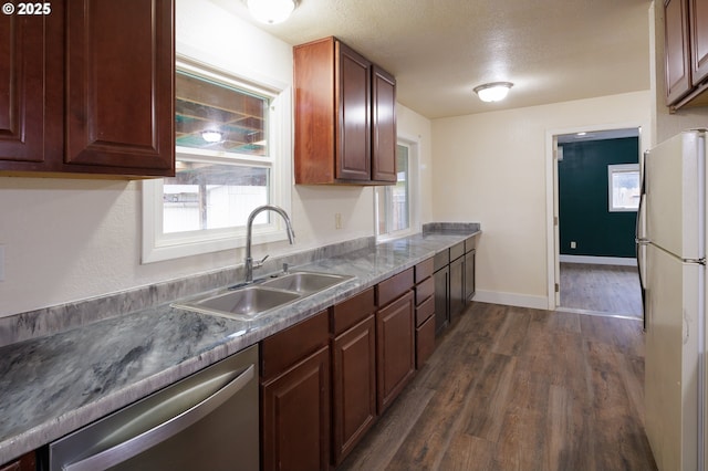 kitchen featuring dishwasher, a textured ceiling, refrigerator, dark hardwood / wood-style flooring, and sink