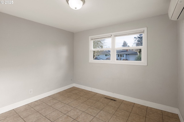 tiled spare room featuring a wall mounted AC