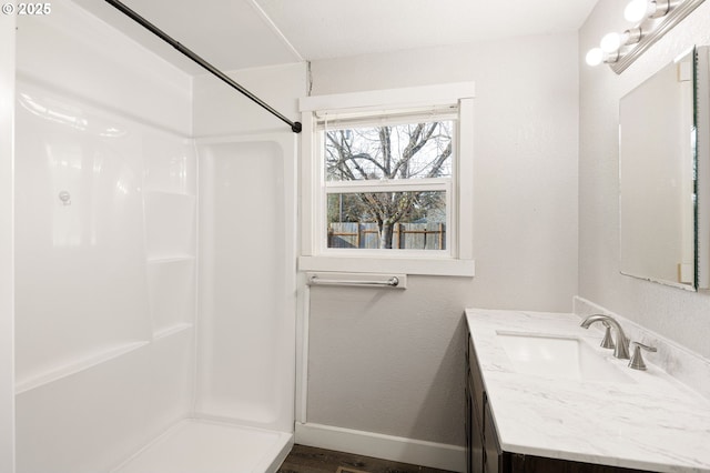 bathroom with vanity and a shower