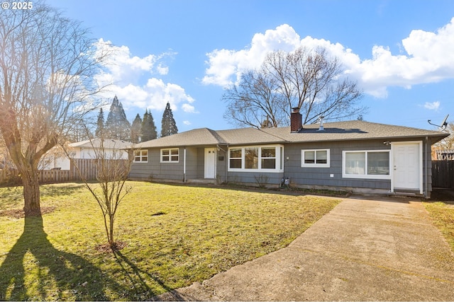 ranch-style home featuring a front yard, fence, and a chimney