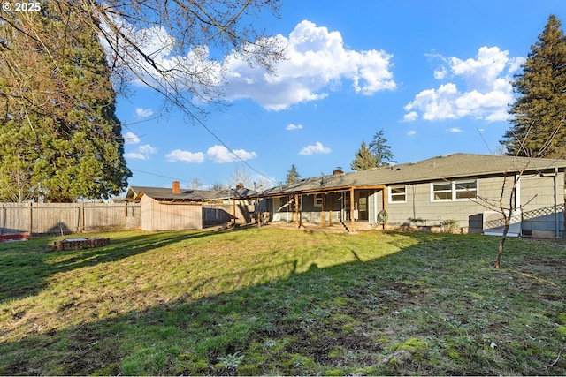 rear view of property featuring a lawn