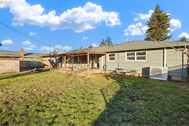 back of property featuring a patio, a lawn, and central AC