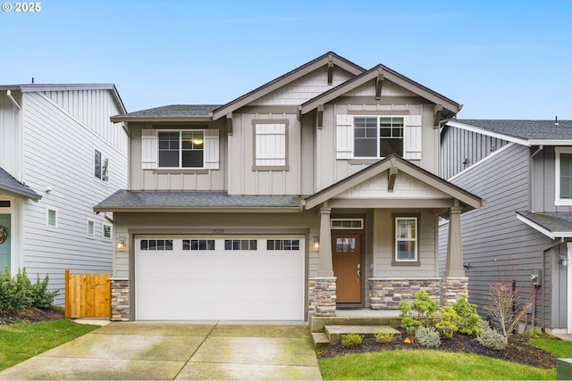 craftsman-style house featuring driveway, an attached garage, board and batten siding, and stone siding