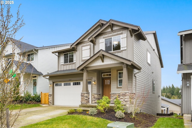 craftsman-style home featuring board and batten siding, concrete driveway, a garage, and stone siding