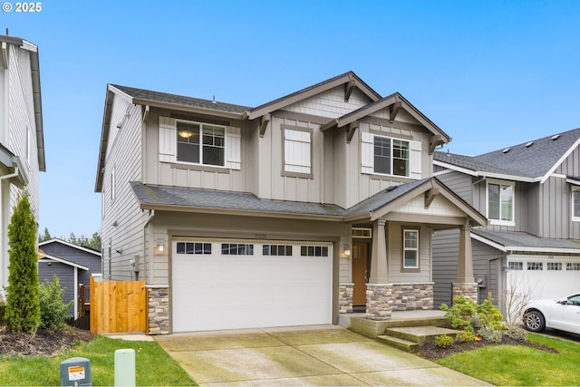 craftsman-style home with stone siding, board and batten siding, driveway, and a garage