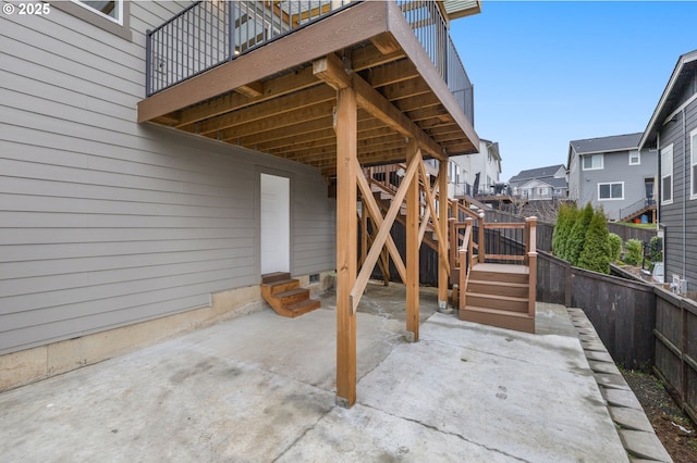 view of patio with fence, stairs, and entry steps