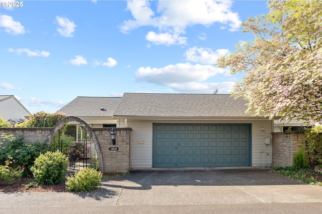 ranch-style house with a garage, fence, a shingled roof, and concrete driveway