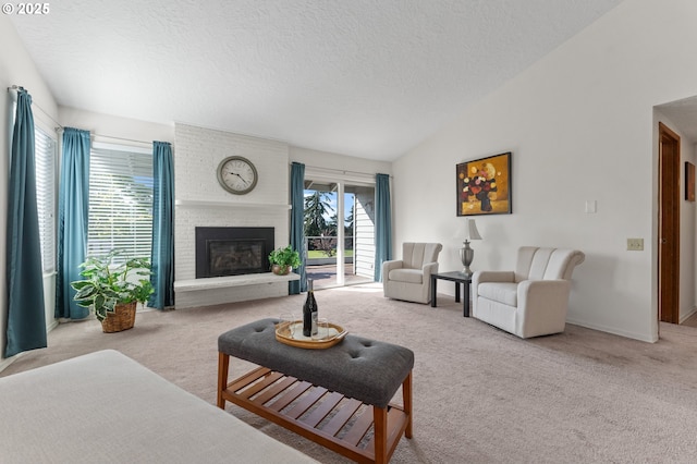 living room featuring a textured ceiling, a brick fireplace, baseboards, lofted ceiling, and carpet