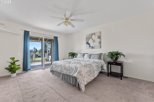 carpeted bedroom with baseboards, a textured ceiling, ceiling fan, and access to exterior