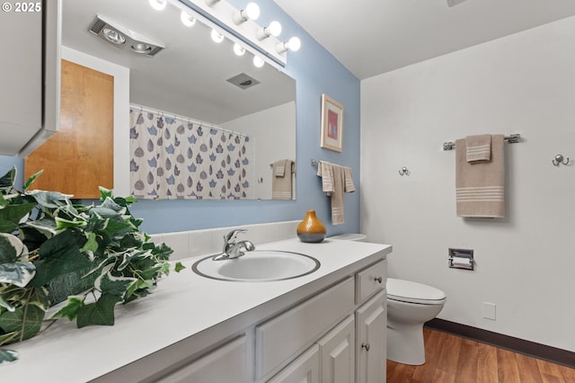 bathroom featuring wood finished floors, vanity, baseboards, toilet, and a shower with shower curtain