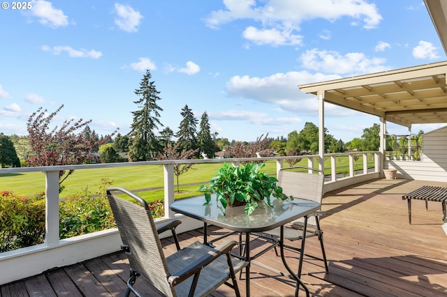 wooden deck with view of golf course and a yard