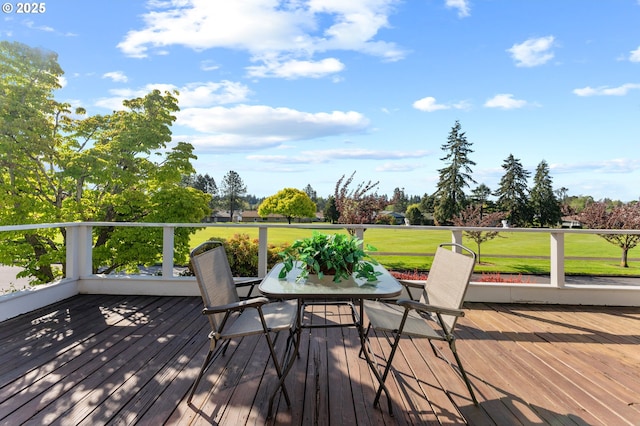 wooden deck featuring a yard and outdoor dining area