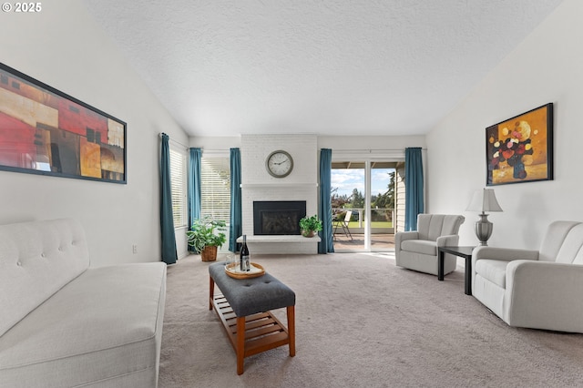 living area with carpet floors, a textured ceiling, and a brick fireplace