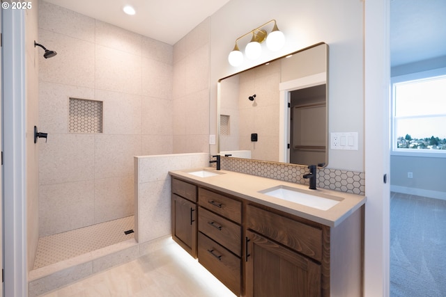 bathroom featuring vanity and a tile shower