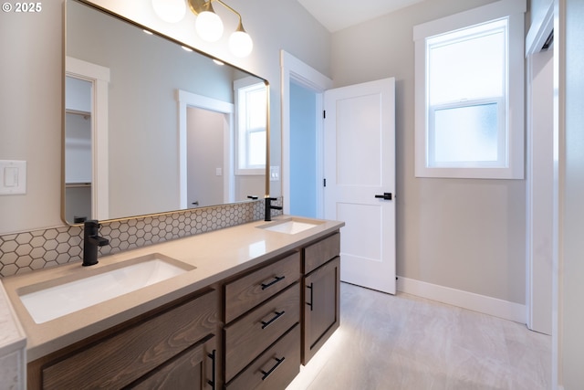 bathroom featuring vanity and backsplash