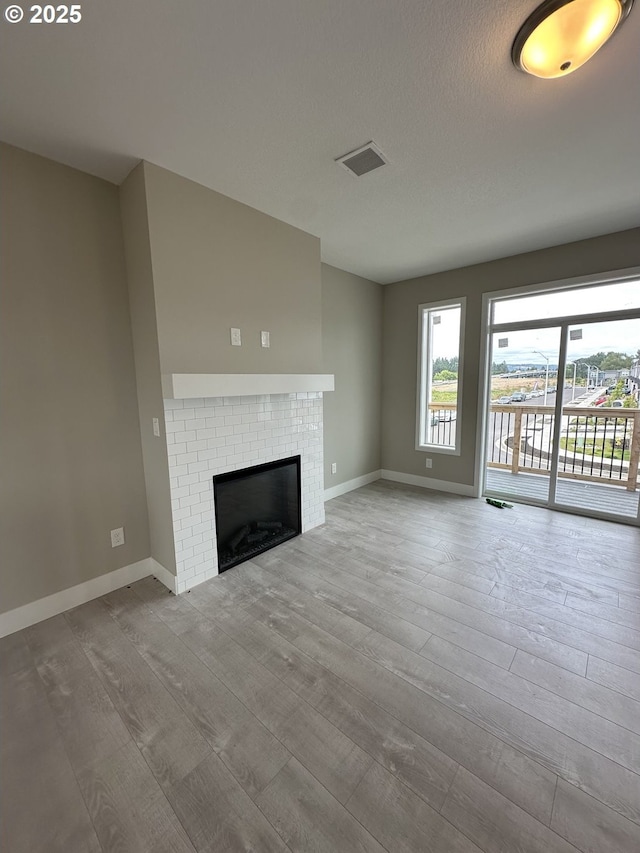 1775 S Murphy Dr, Newberg, OR 97132 - unfurnished living room with wood finished floors and a brick fireplace