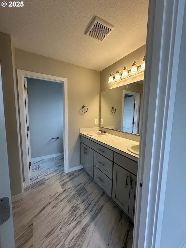 1775 S Murphy Dr, Newberg, OR 97132 - bathroom featuring double vanity, a textured ceiling, and marble look tile flooring