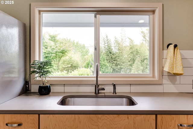 kitchen with a sink, plenty of natural light, and light brown cabinets