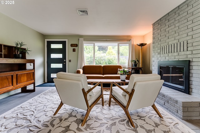 tiled living room with a brick fireplace