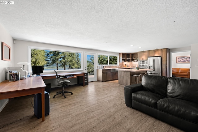 37333 NE Reed Rd, Corbett, OR 97019 - living area featuring a desk, a textured ceiling, light wood-type flooring, and plenty of natural light