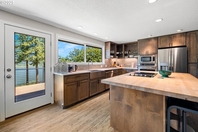 37333 NE Reed Rd, Corbett, OR 97019 - kitchen with stainless steel appliances, butcher block counters, wine cooler, light wood-style floors, and recessed lighting