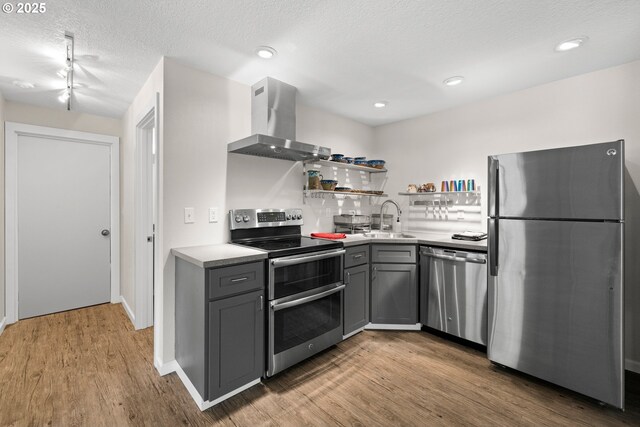 37333 NE Reed Rd, Corbett, OR 97019 - kitchen with stainless steel appliances, island exhaust hood, gray cabinets, wood finished floors, and light countertops