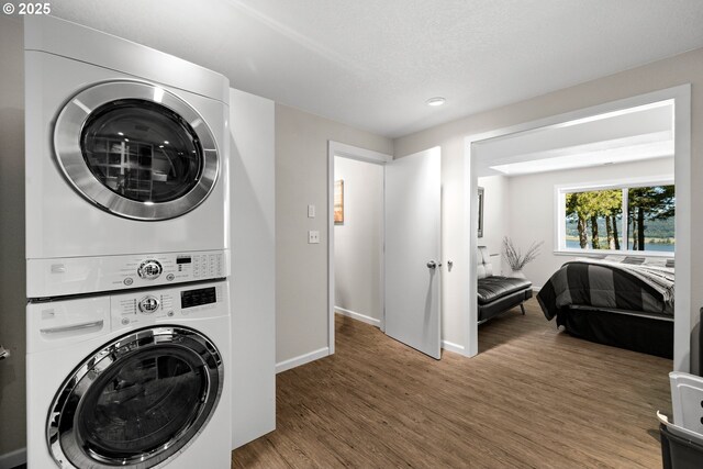 37333 NE Reed Rd, Corbett, OR 97019 - washroom with stacked washer / dryer, wood finished floors, and recessed lighting